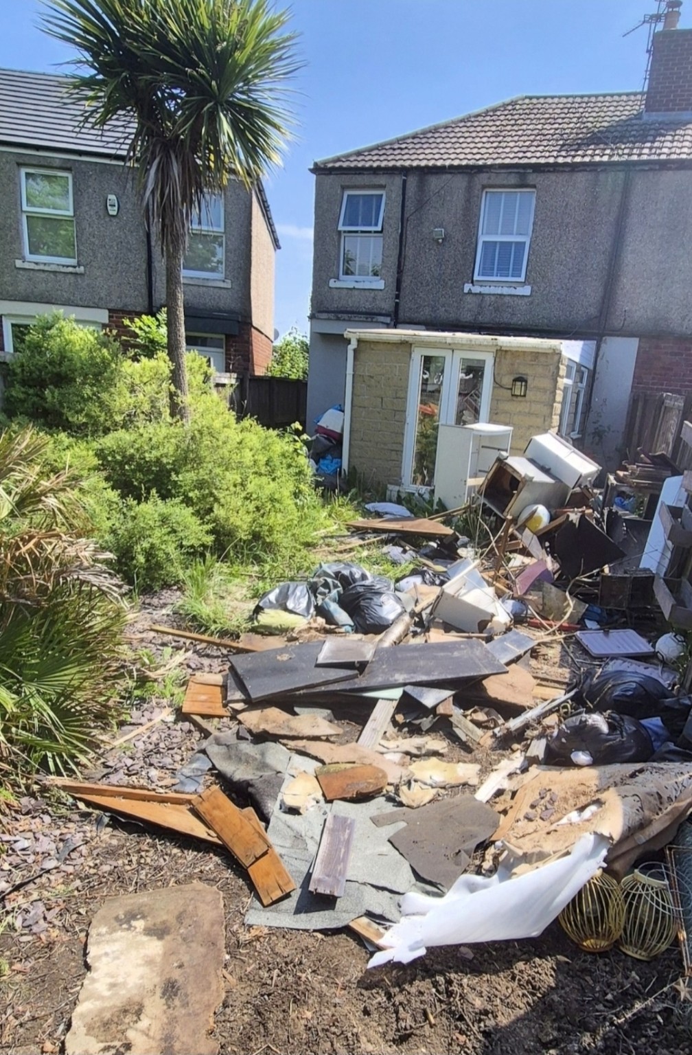 Before: unwanted items and waste outside a home