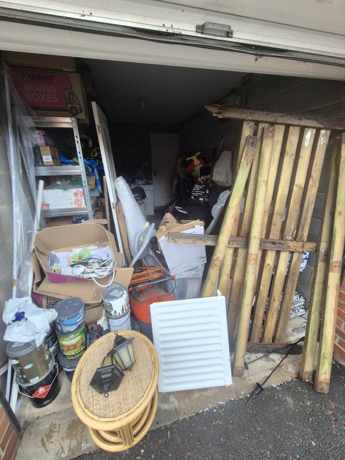 Garage filled with stored items, boxes and unwanted furniture
