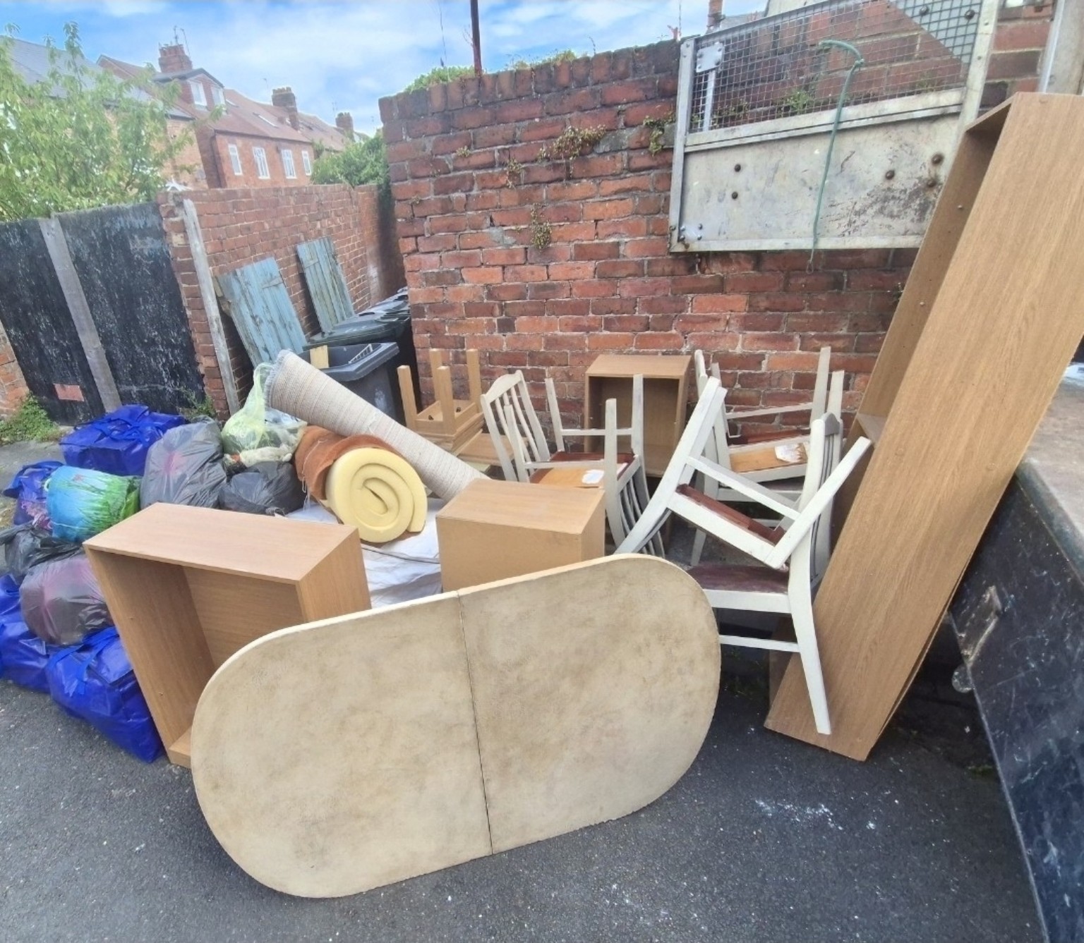 Furniture and bagged contents prepared for a property clearance